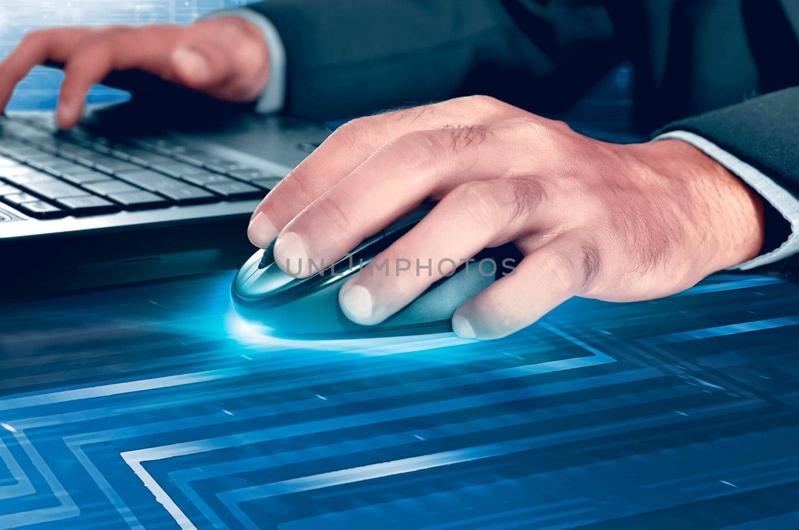 Hands of businessman on mouse and laptop keyboard with digital background