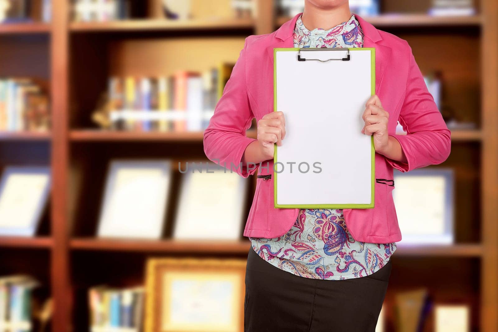 Business people holding blank clipboard for copyspace on the office