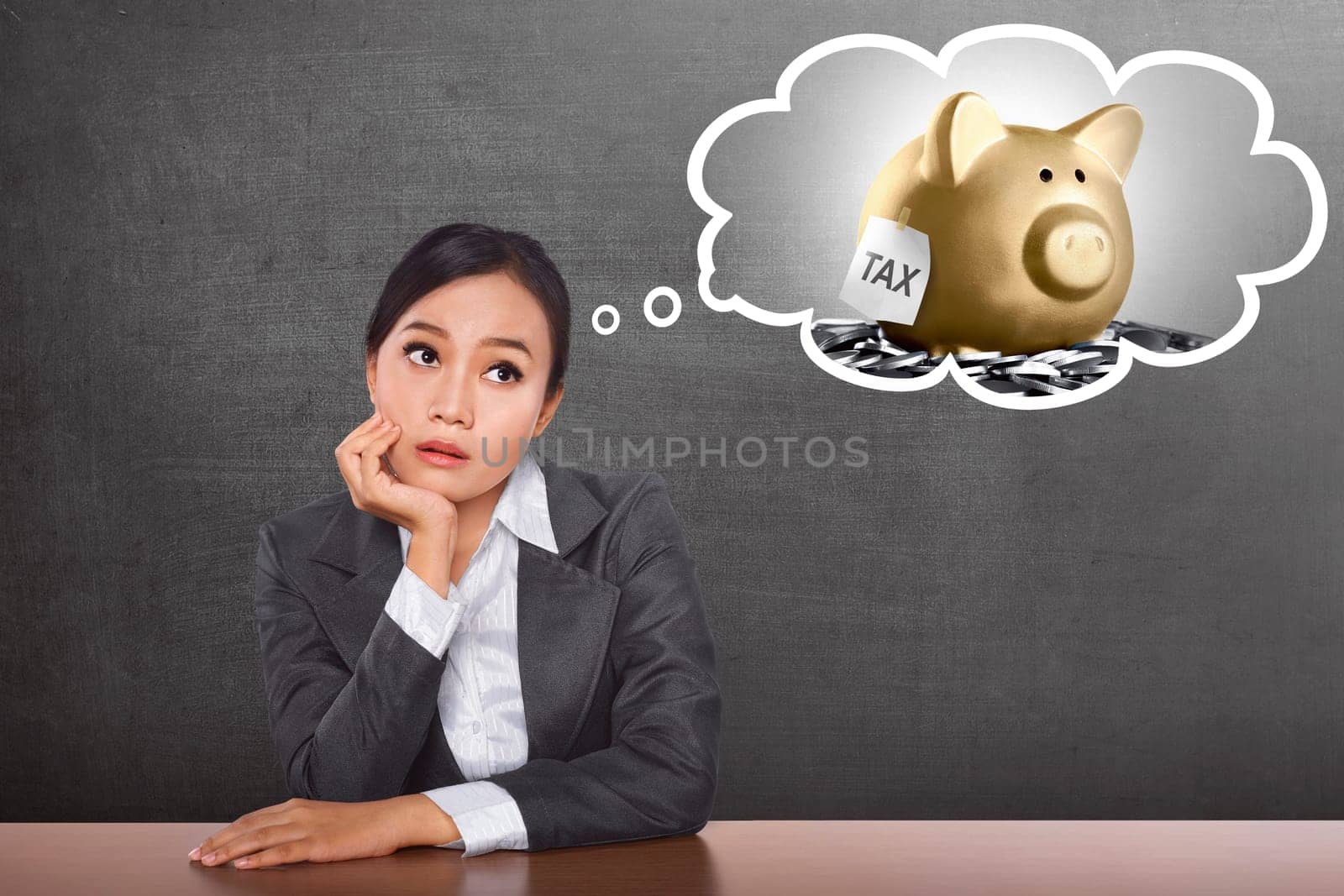 Confused asian business woman thinking her Tax payment with blackboard background