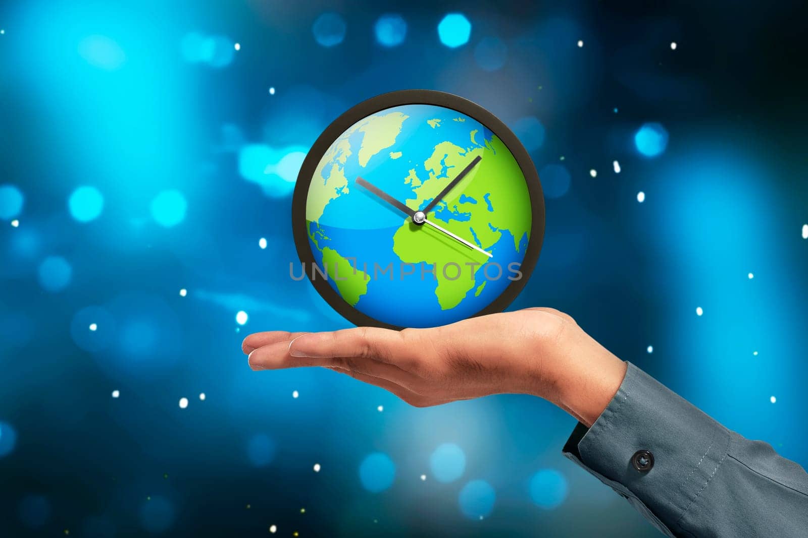 People hand showing earth globe clock against blue light background