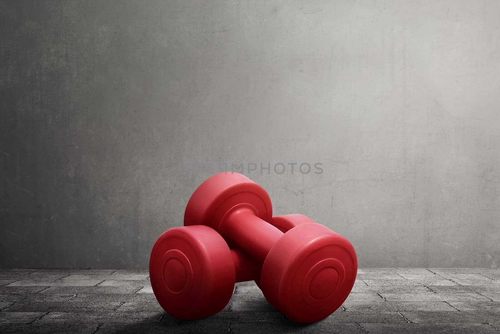 Two red dumbbells equipment on black wall background