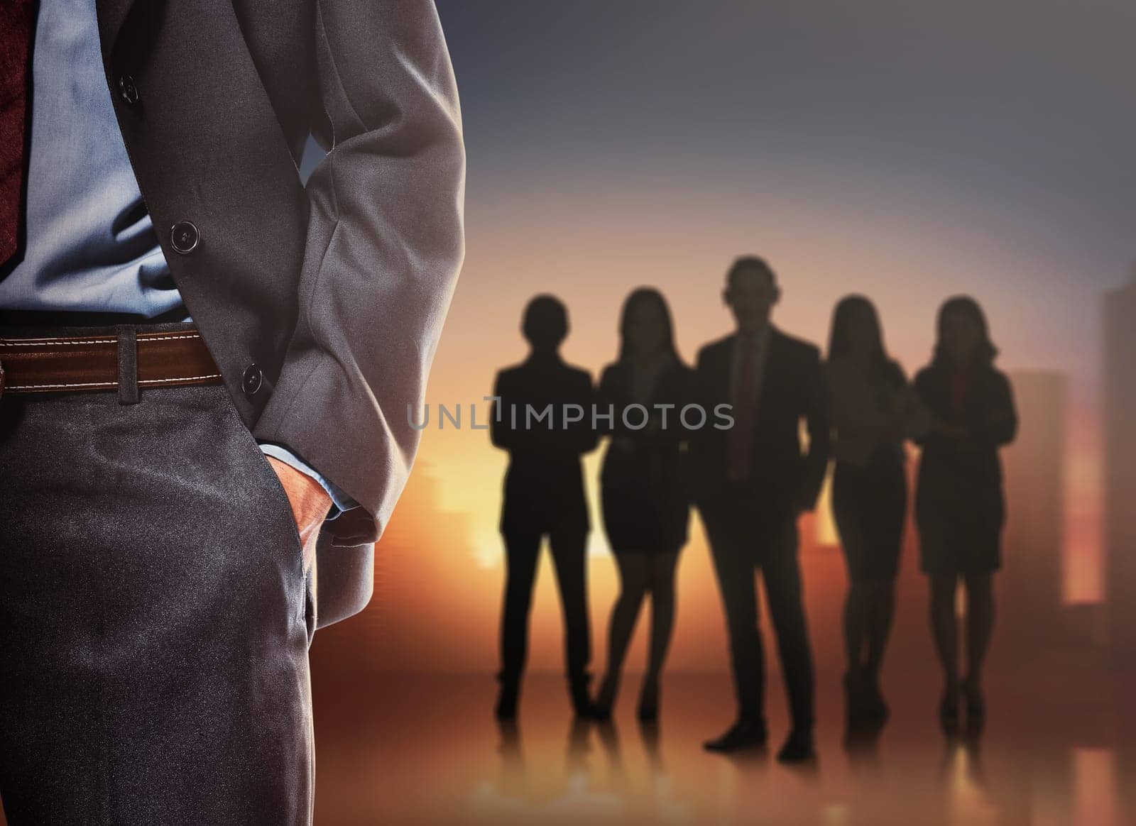 Business man with silhouettes of group business people on a cityscape background