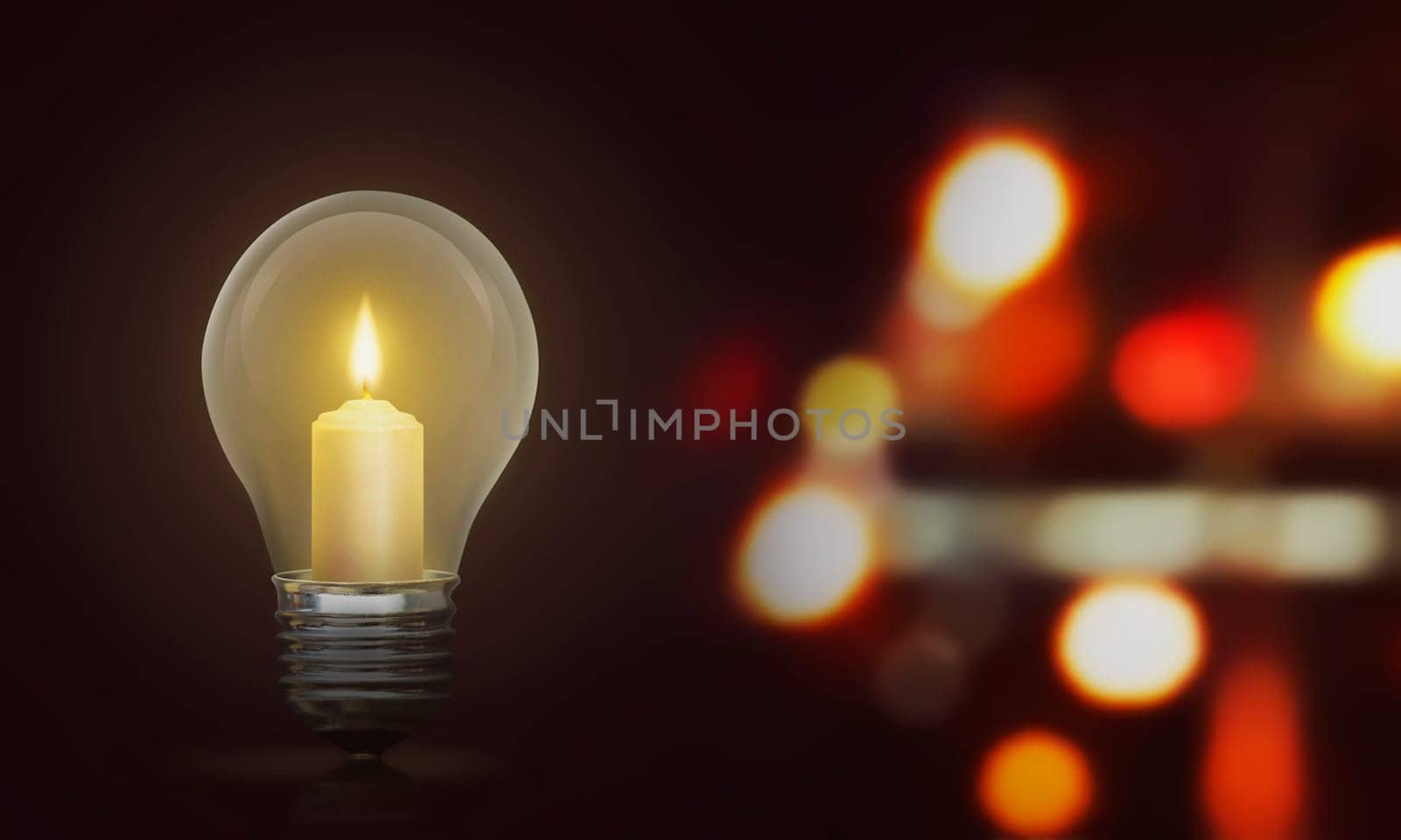 Candlelight on light bulb illuminate the dark room against blurred light background