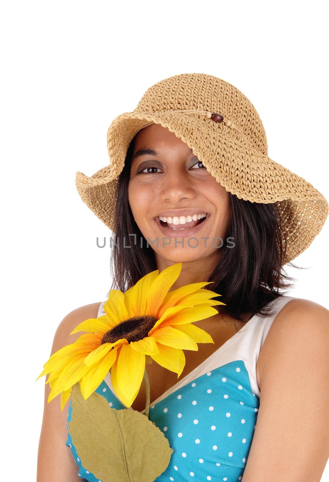 A beautiful smiling Hispanic woman, wearing a straw hat and holding a.yellow sunflower, isolated for white background..
