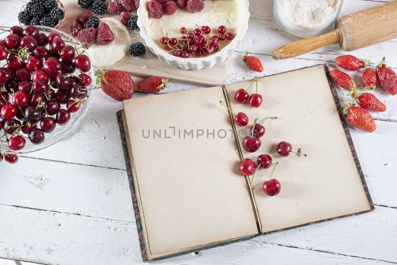 cookbook with ingredients and red fruits