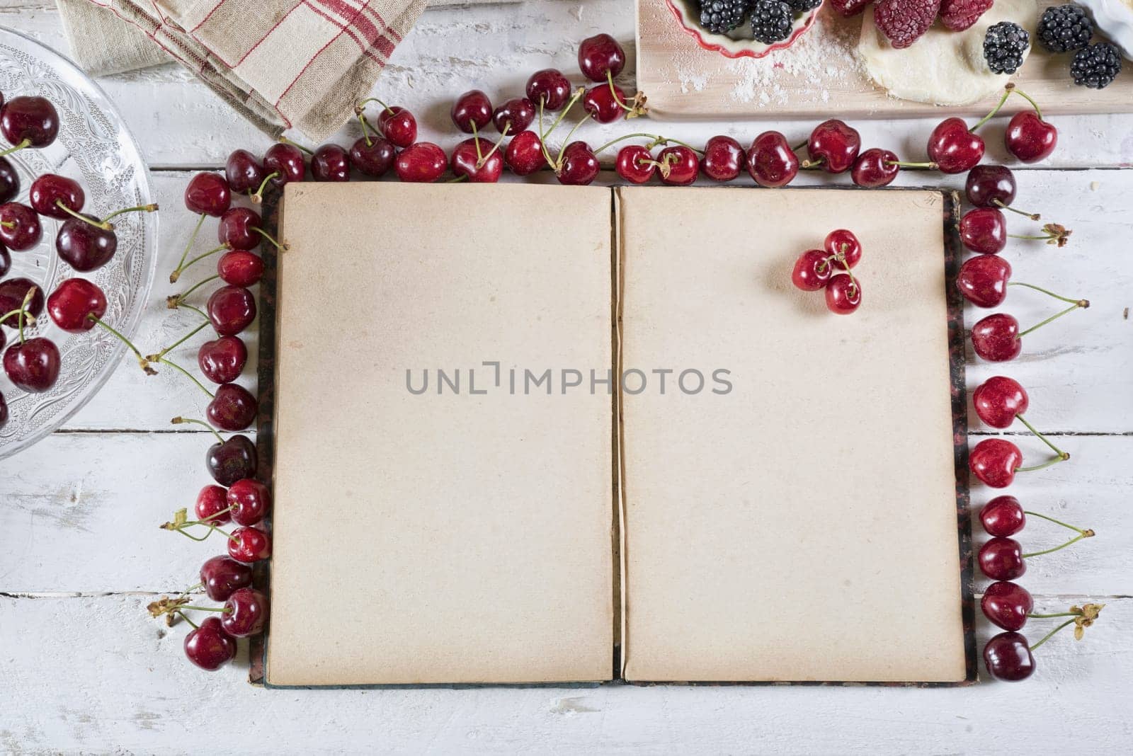 cookbook with ingredients and red fruits