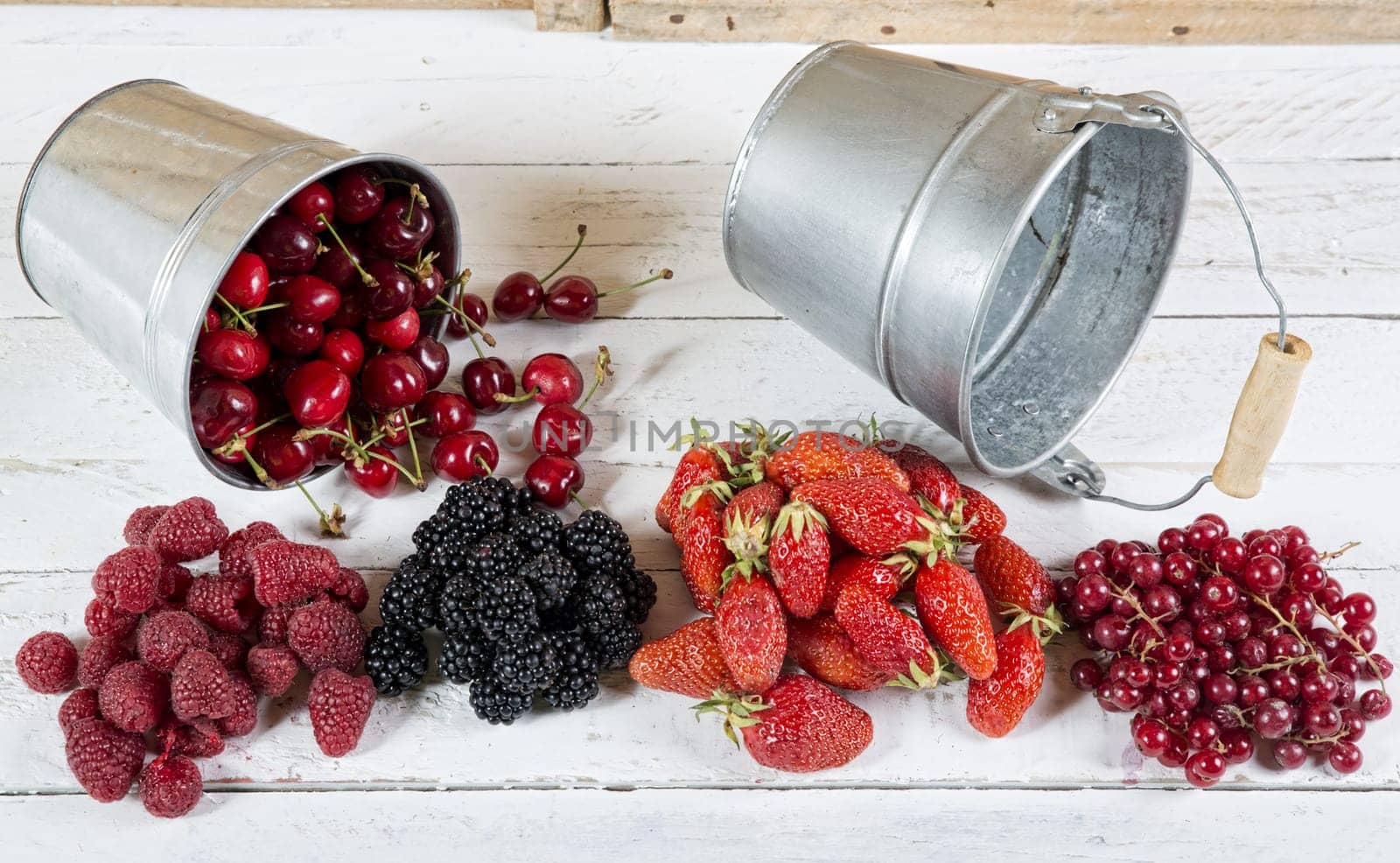 assortment of red fruit on the white table