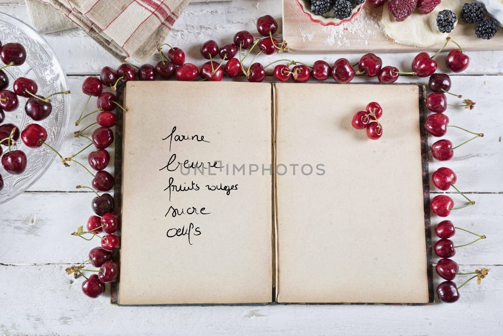 cookbook with ingredients and red fruits
