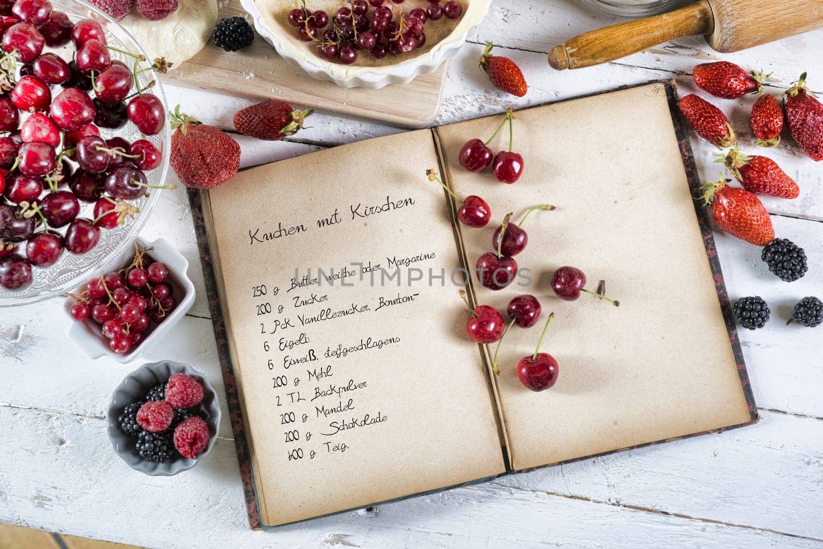 cookbook with ingredients and red fruits