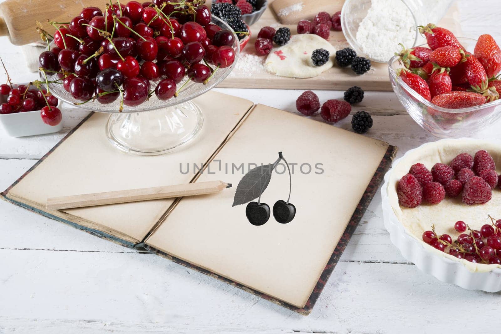 cookbook with ingredients and red fruits