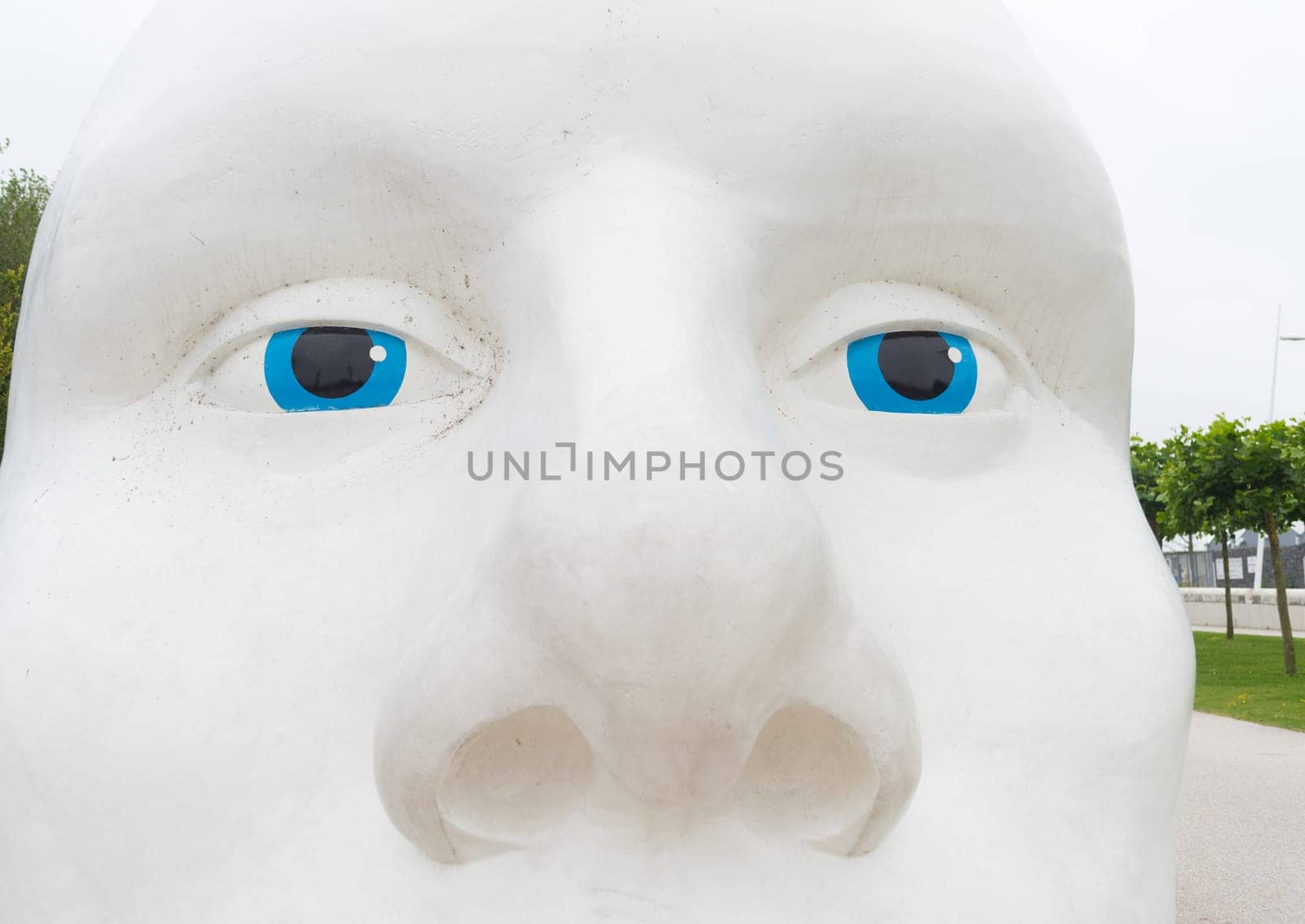 LELYSTAD, NETHERLANDS - AUGUST 7, 2016: closeup of a statue of a white head with blue eyes, made by Henk Hofstra
