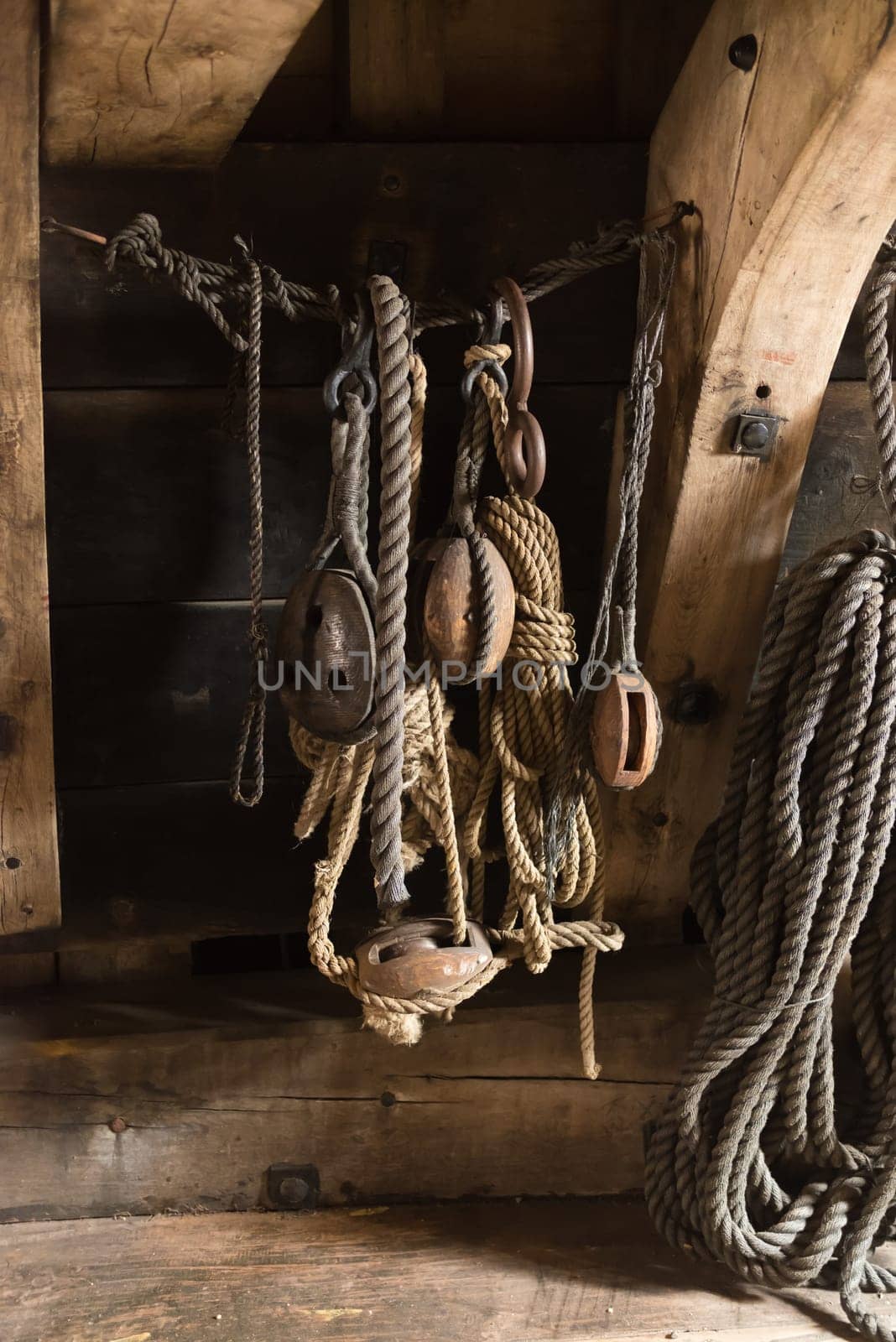 ancient wooden sailboat pulleys and ropes in an old restored dutch VOC ship