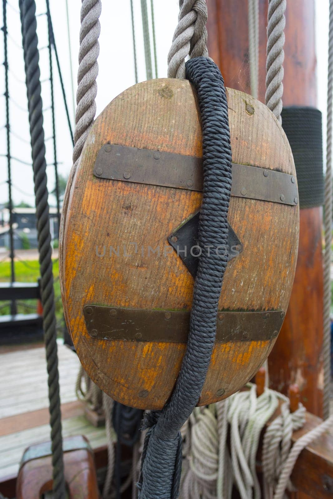 ancient wooden sailboat pulley on an old restored dutch VOC ship