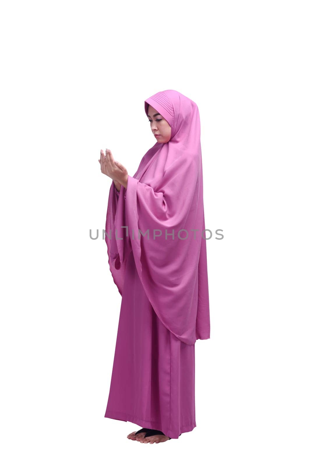 Beautiful asian muslim woman wearing hijab praying isolated over white background