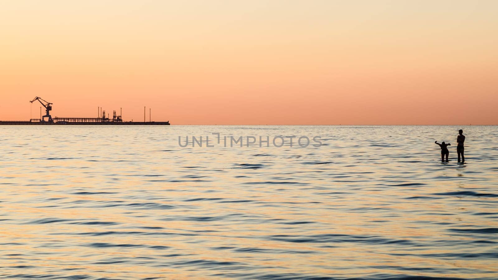 Couple bathing at sunset in the sea