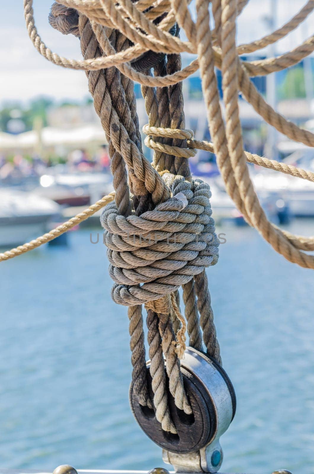 Rigging on the old sailboat against the background of modern yachts