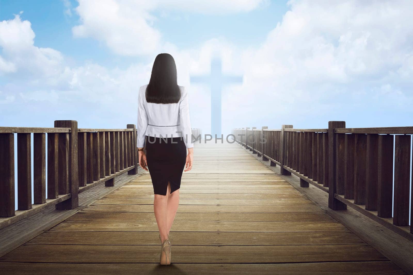 Back view of asian woman walking to cross shape on the cloud