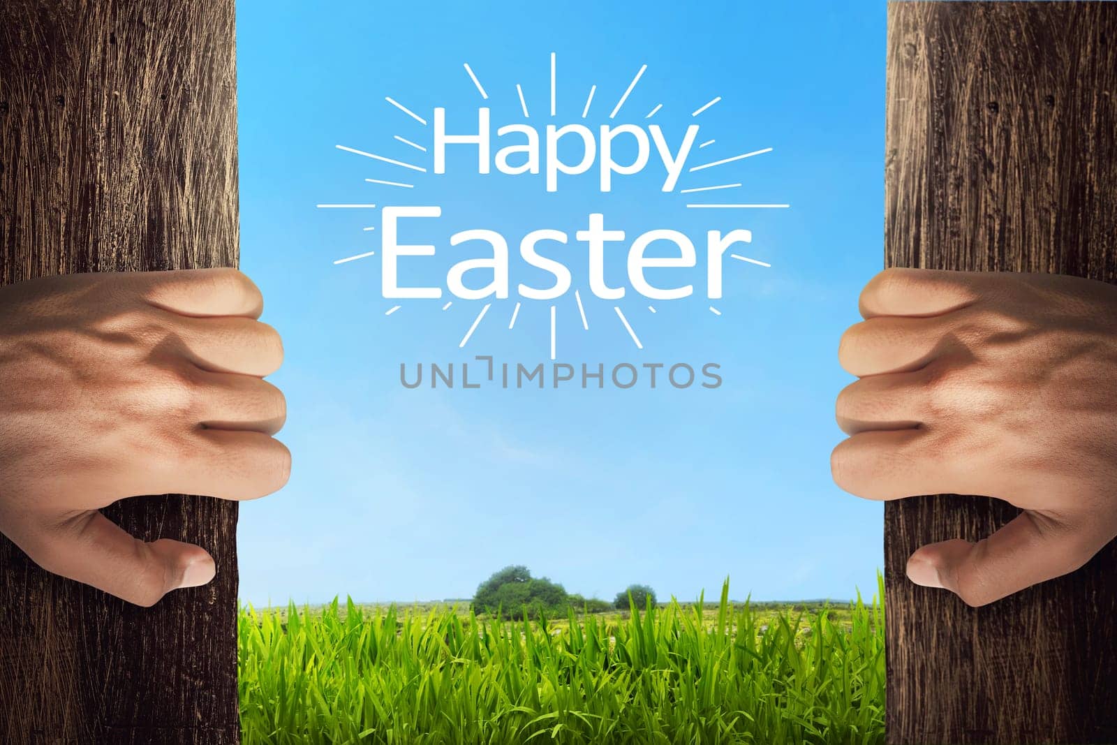 People hand opening door with happy easter greetings on meadow grass