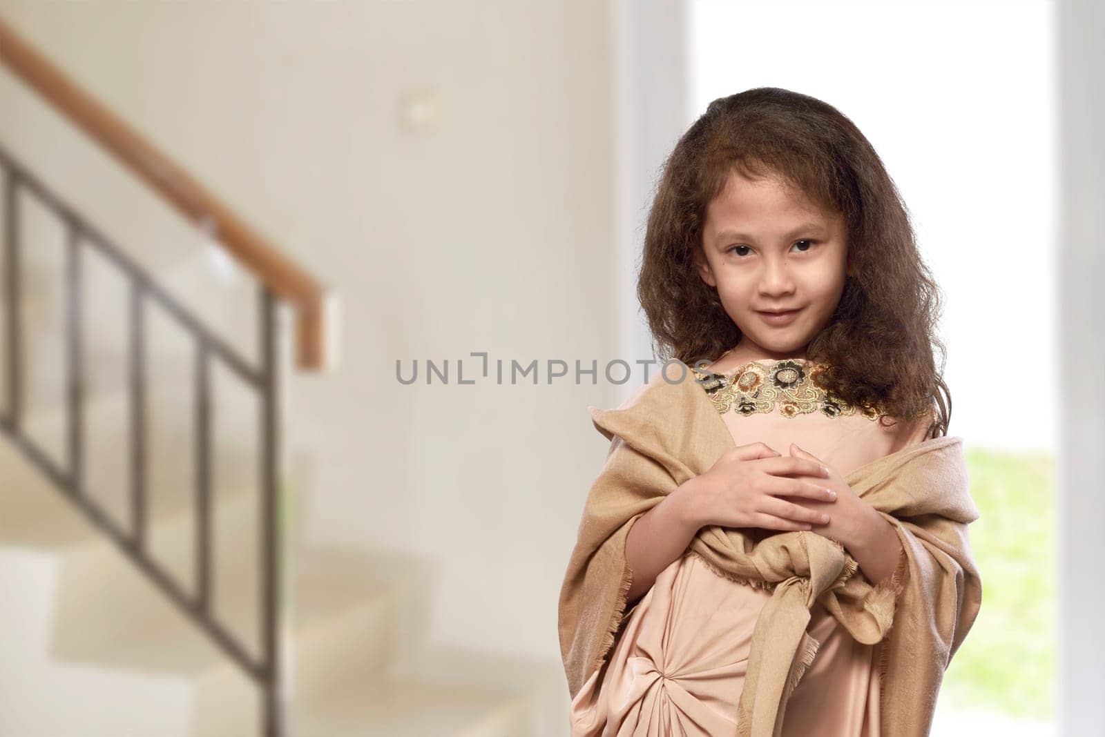 Asian muslim kid with traditional dress in the home
