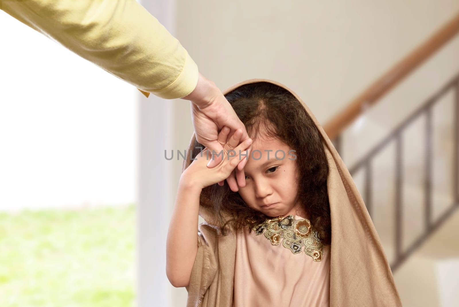 Asian muslim girl kissing hand parents as respect in the home