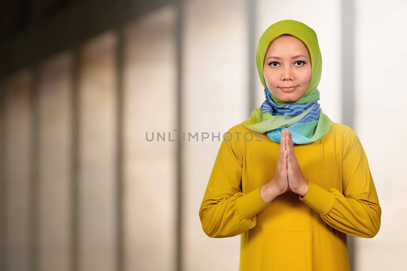 Beautiful asian muslim woman praying in the mosque