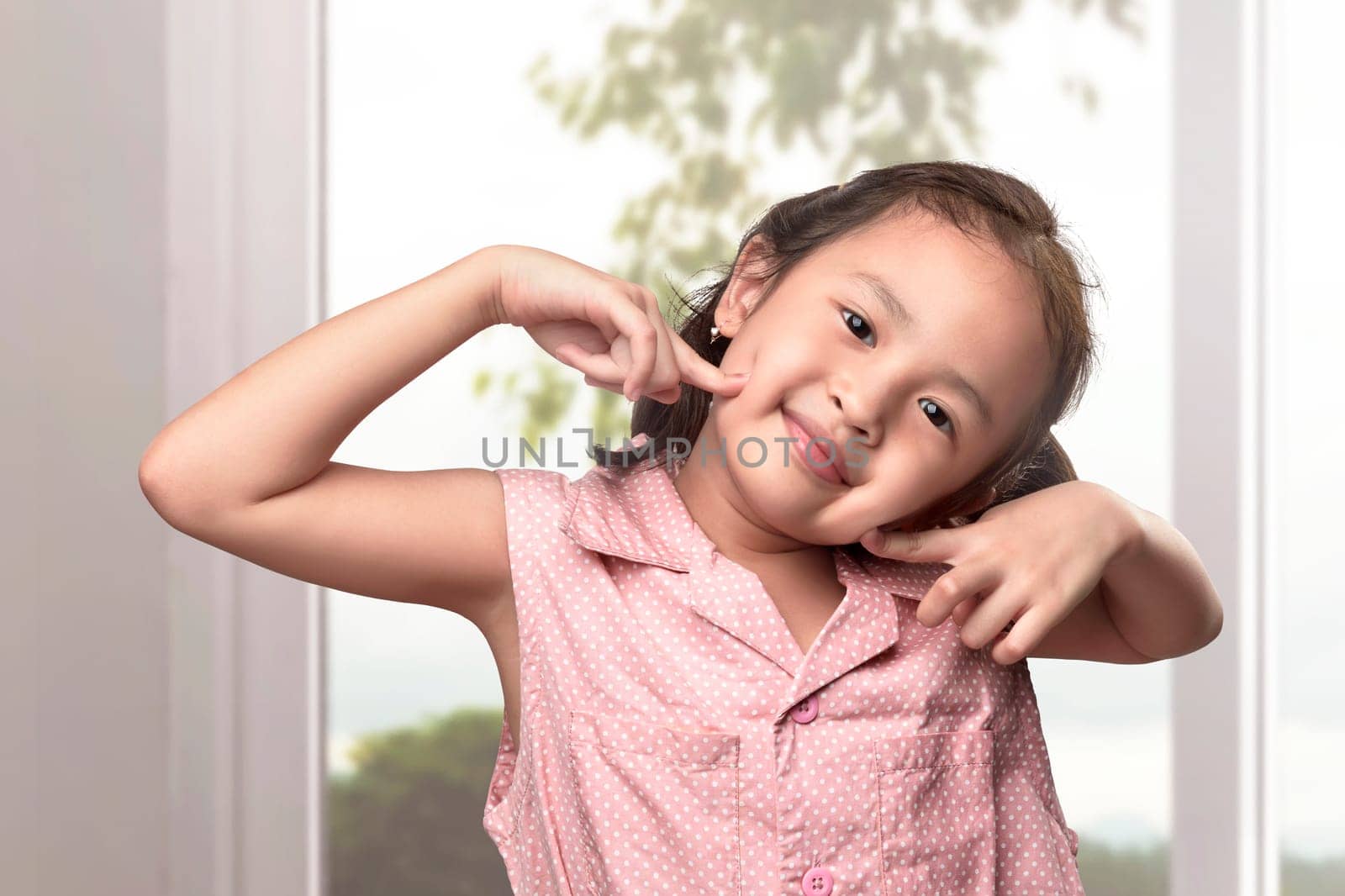 Cheerful asian little girl having fun in the home