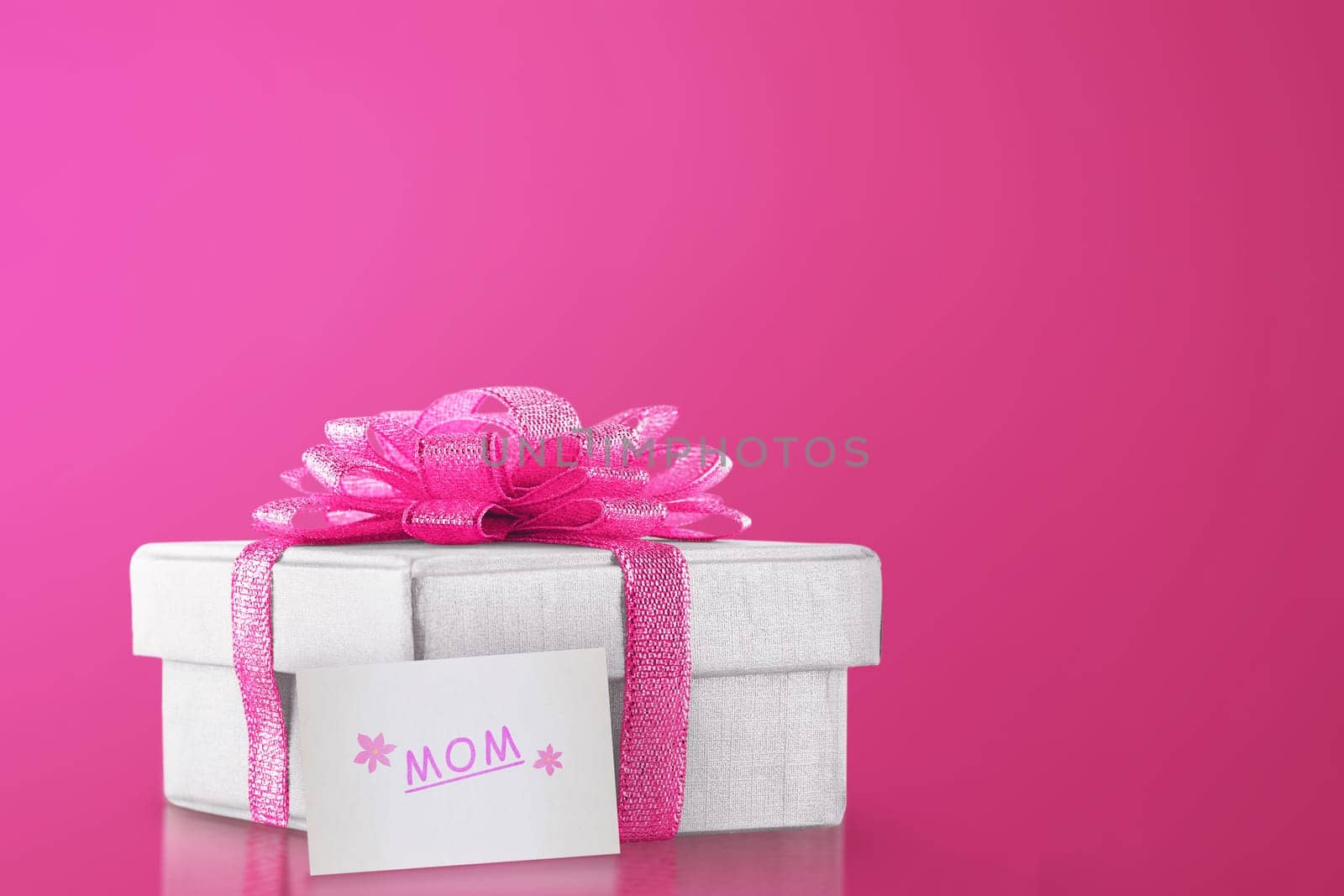 Gift box with pink ribbon for mom. Mother's Day Concept.