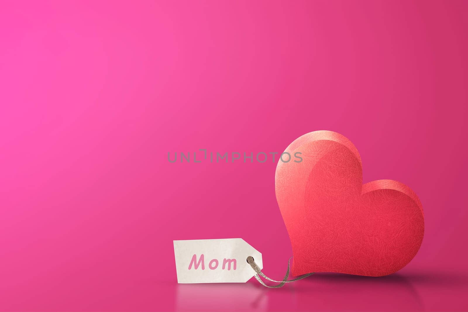 Red heart shape with mom text on label over pink background