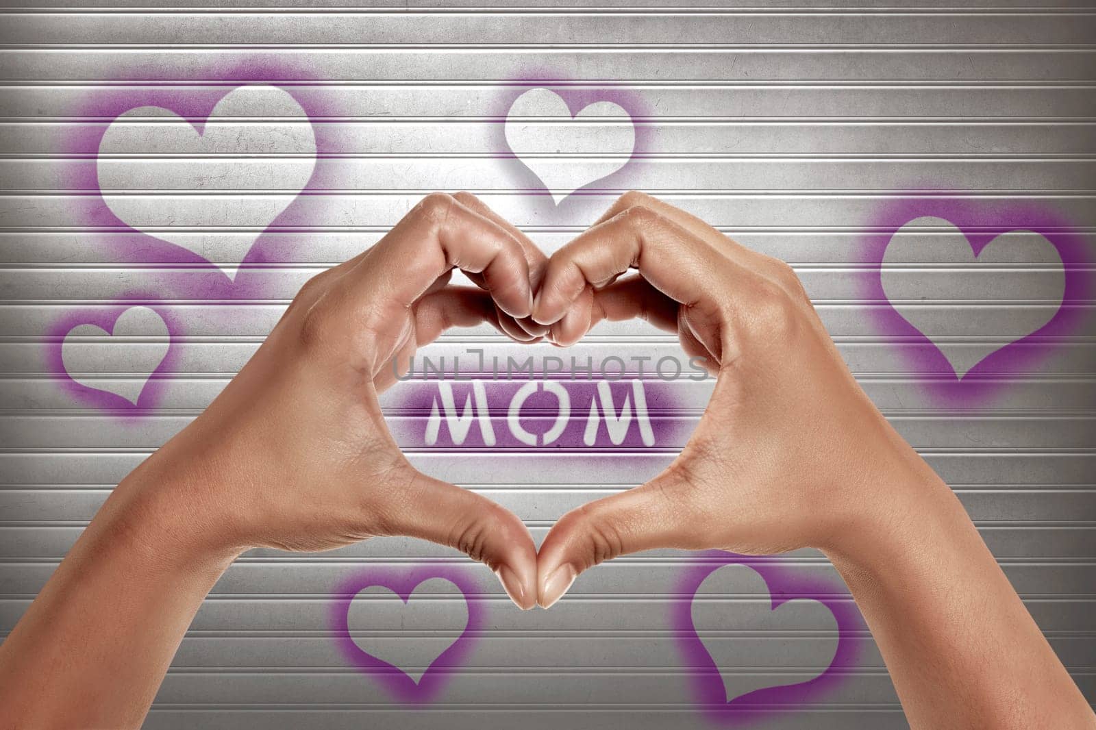 People hands in shape of heart with mom text on the metal door