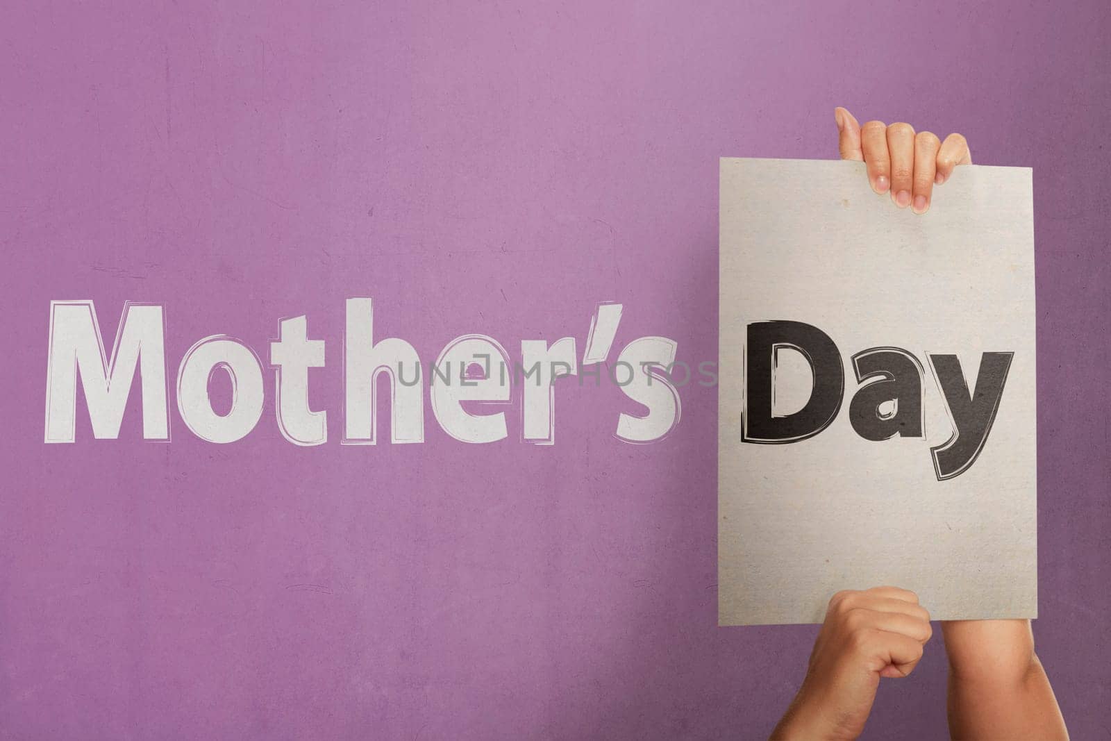 People hand holding white paper to make greeting Mothers day on the pink wall