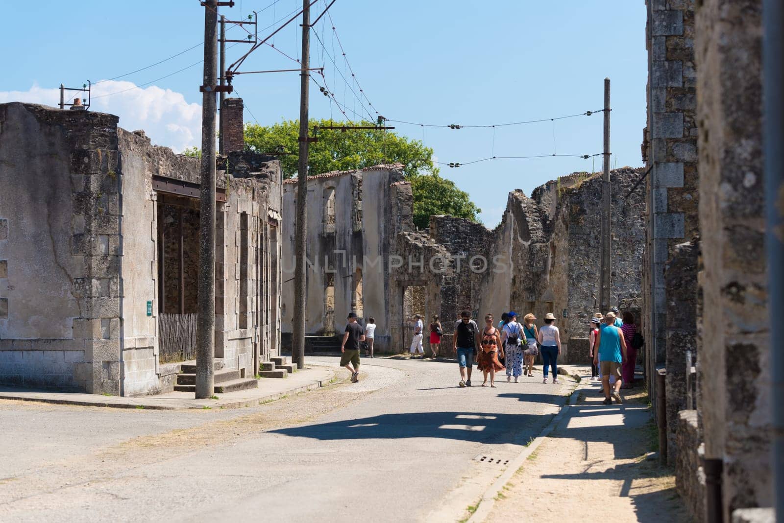 ORADOUR-SUR-GLANE, FRANCE - AUGUST 15, 2016: Tourists between the ruins of the by the nazis destroyed french village in WW2
