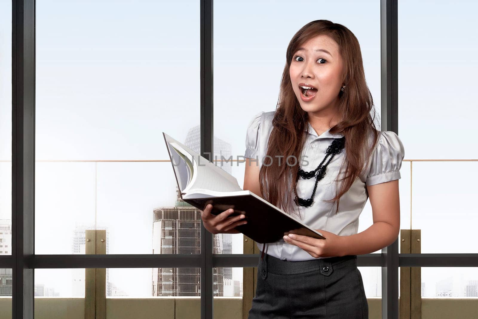 Asian business woman with surprised face expression in the office