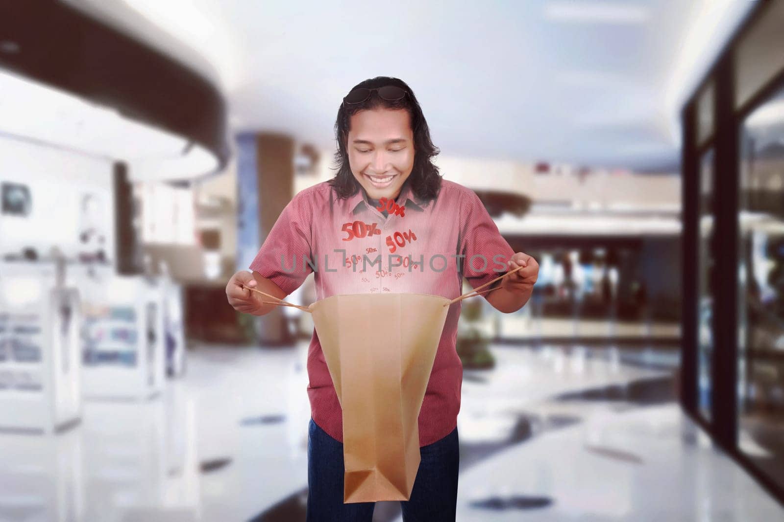 Image of shocking long haired man open shopping bag