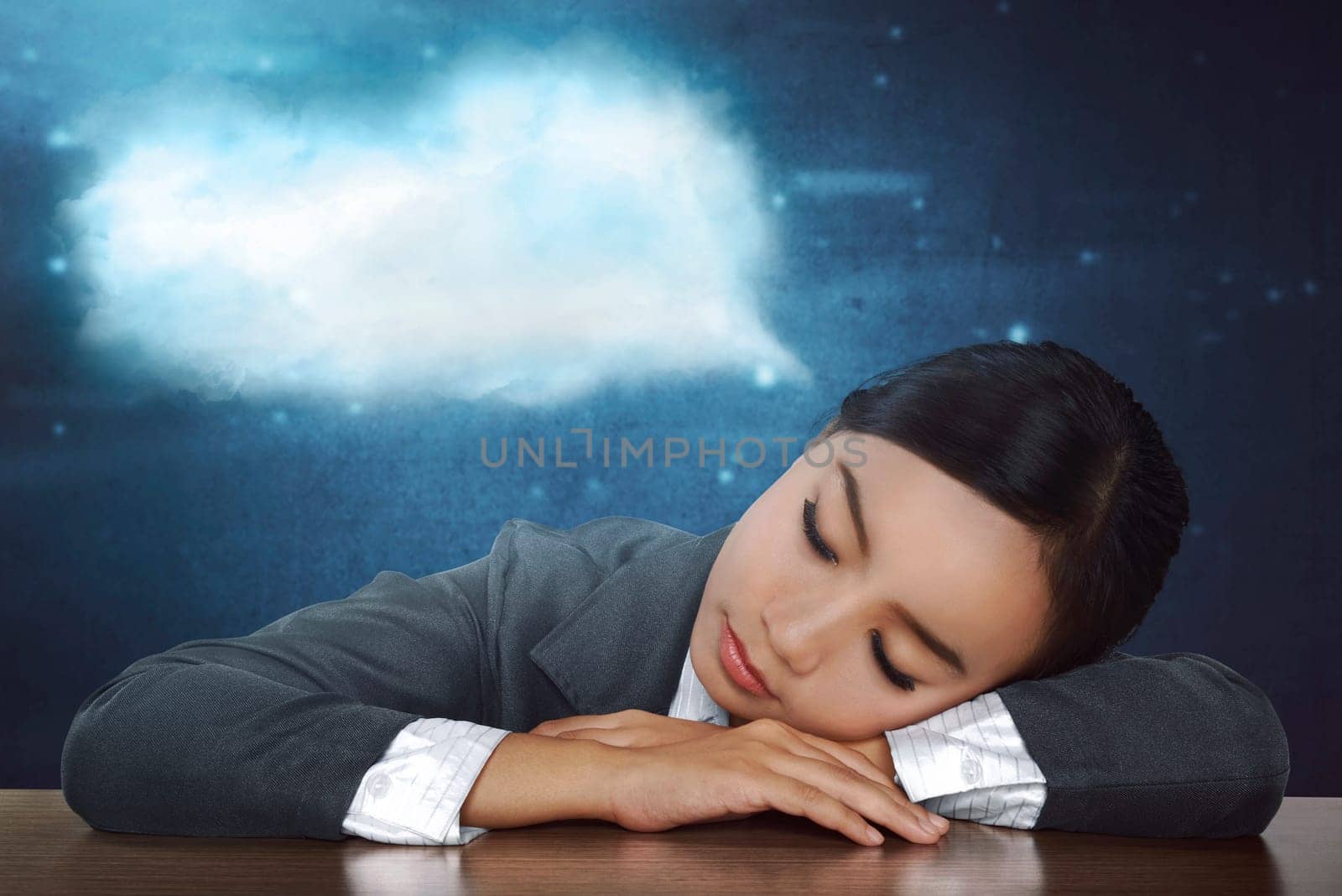 Overworked asian business woman sleeping in desk at work in her office