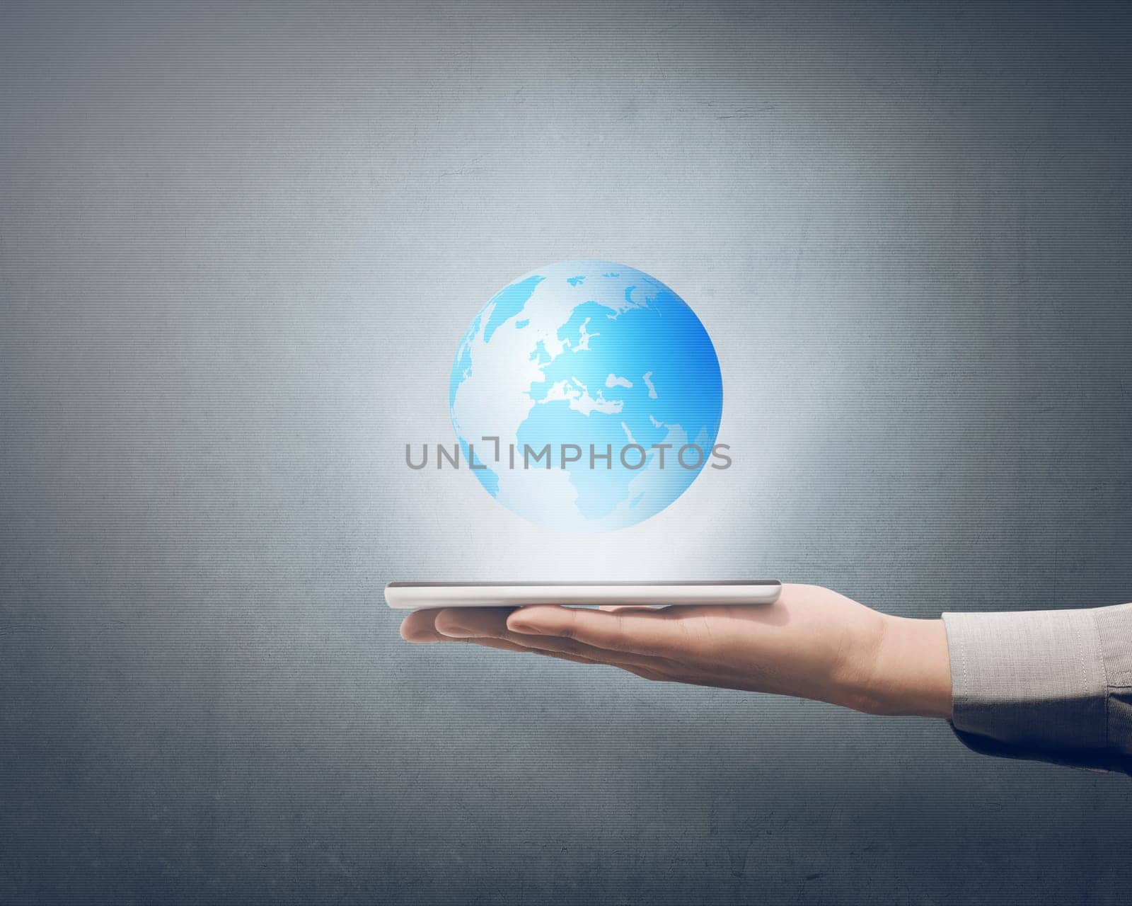 Businessman holding smart phone in his hand with globe on it over grey background