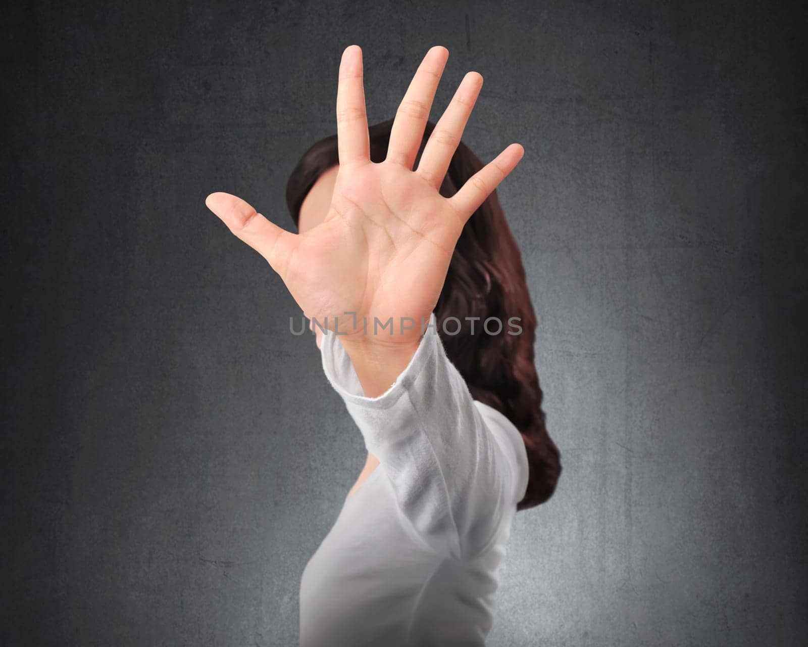 Portrait of asian woman showing stop with hand gesture with black wall background