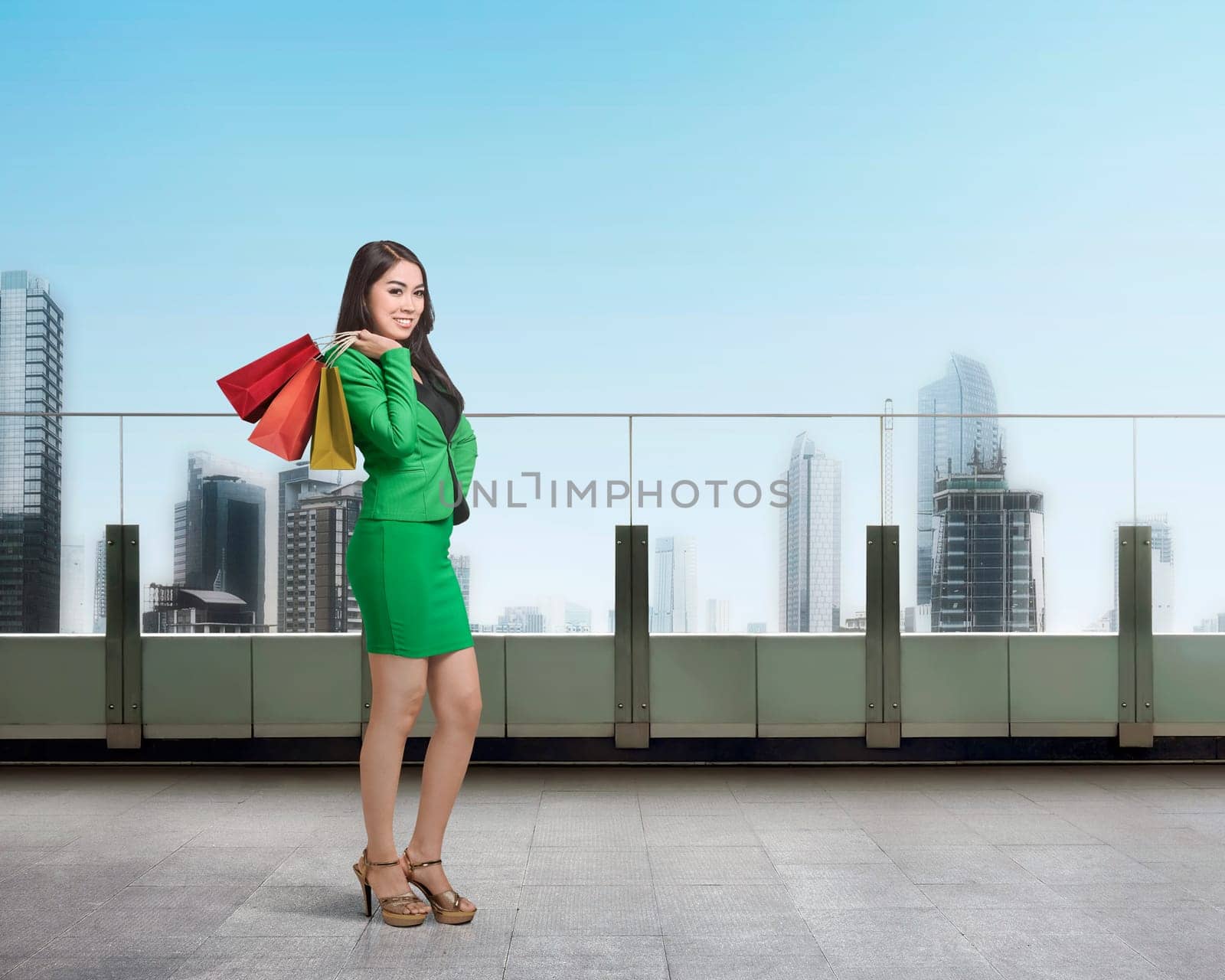 Young asian business woman with shopping bag in the terrace mall