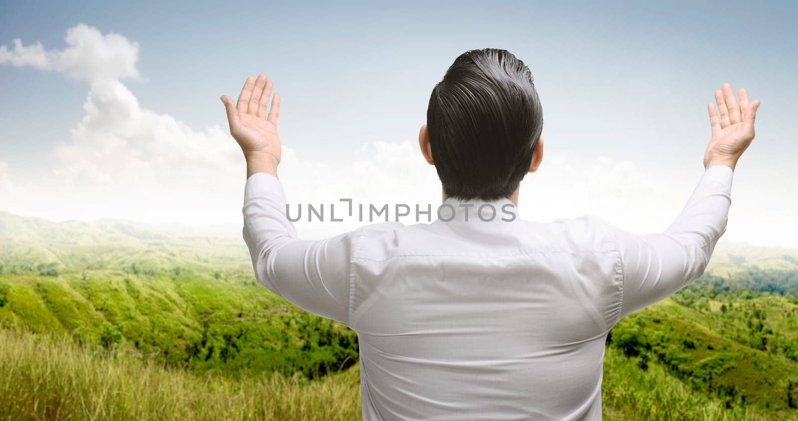 Rear view of asian muslim man praying to god at outdoor