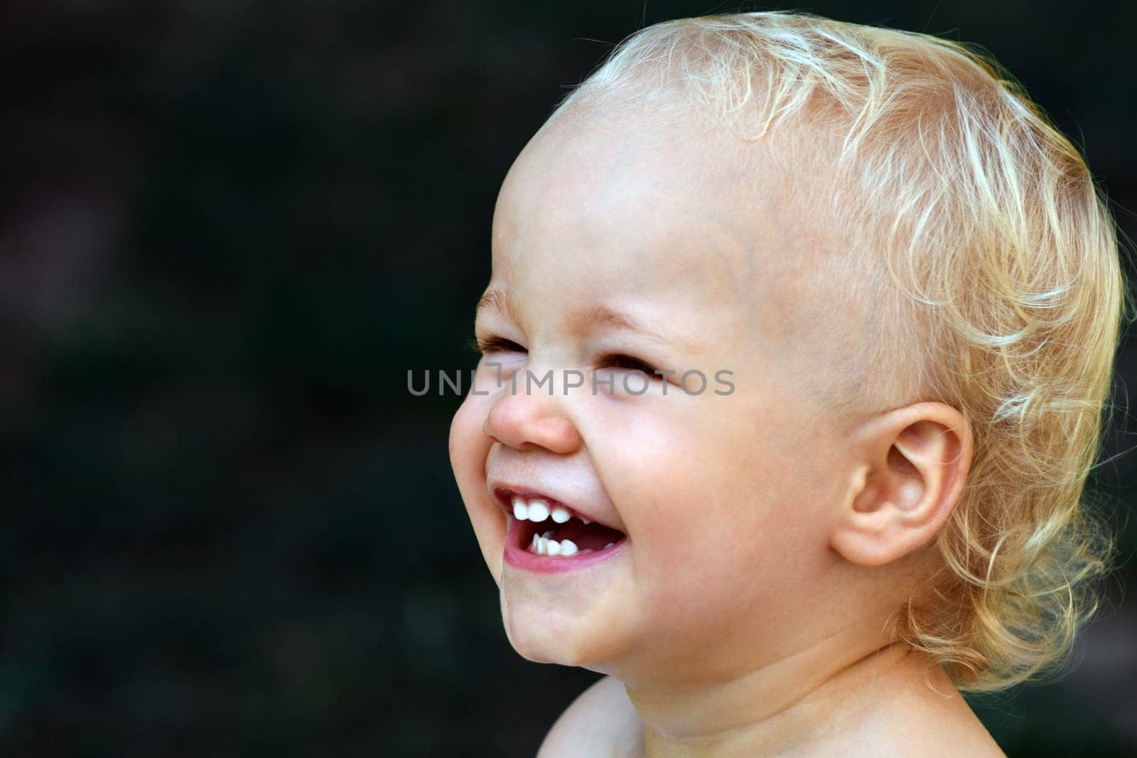 Portrait about a little happy laughing child.