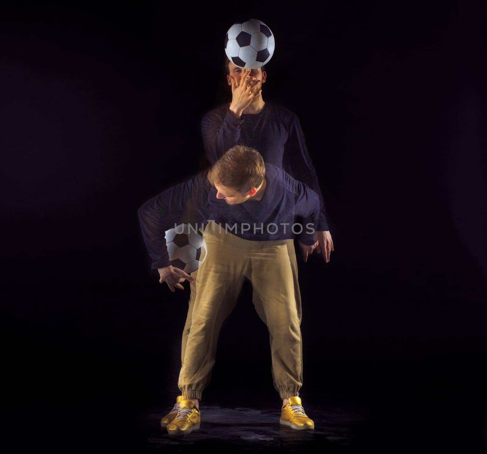 A portrait of a fan with ball on gray studio background. Freestile concept. Stroboscope shooting technique