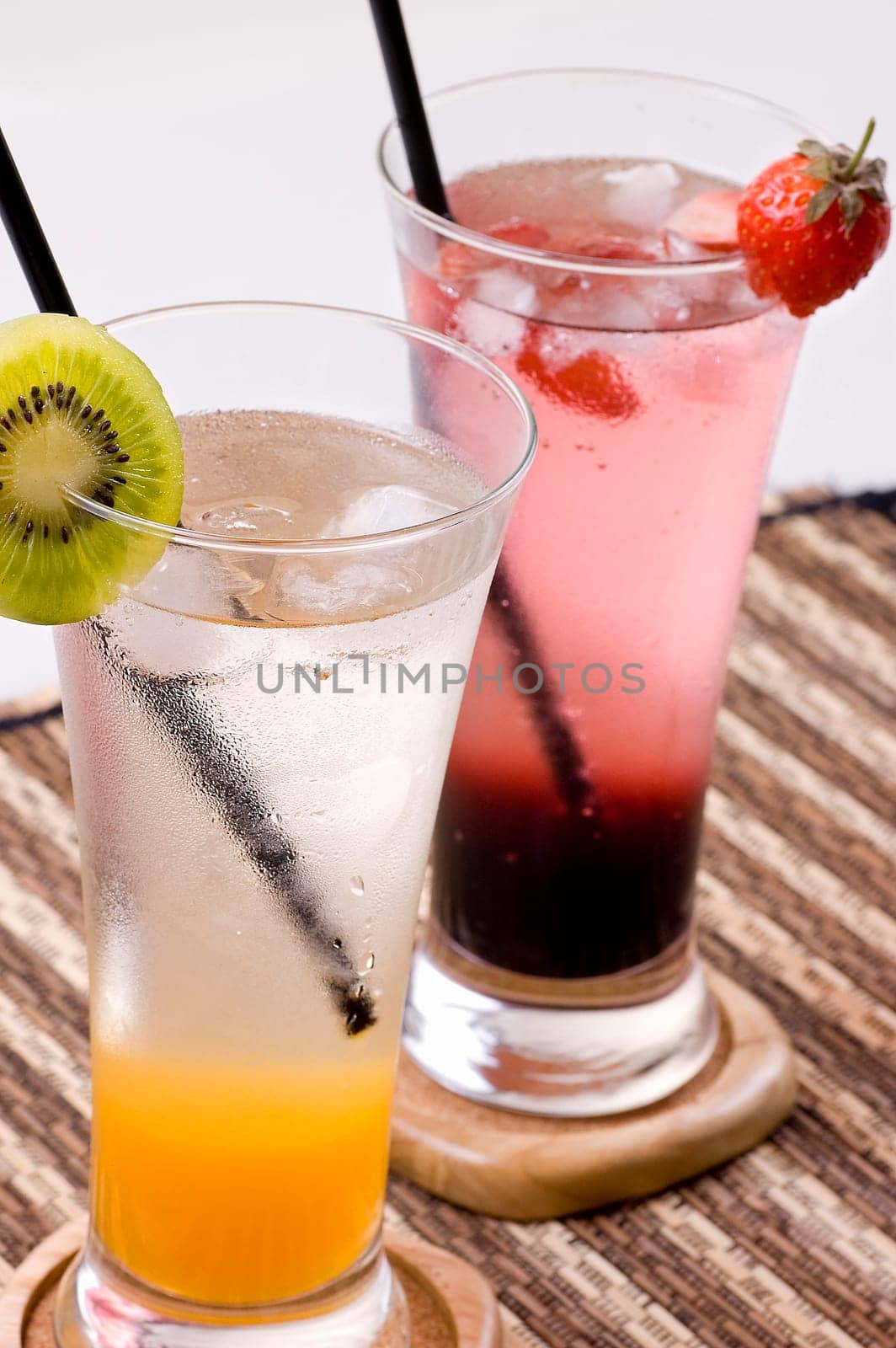 Two glasses of orange and strawberry squash