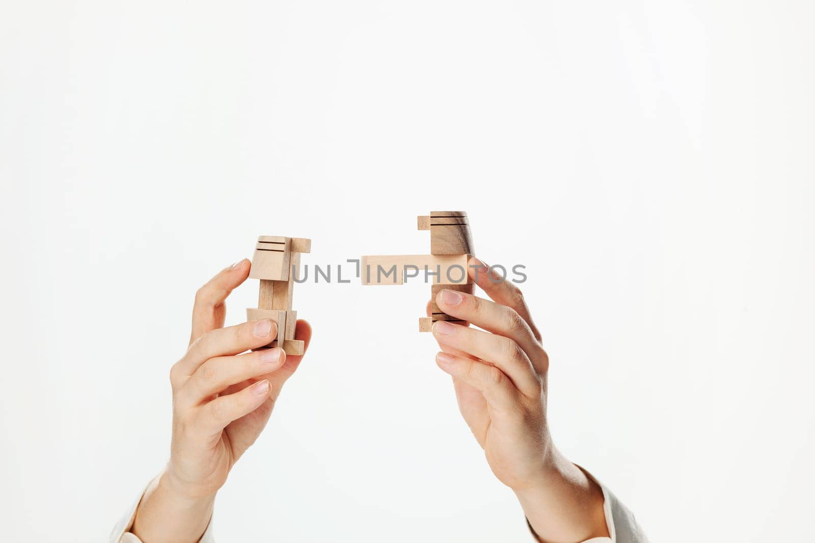 The wooden puzzle in male hand isolated on white background