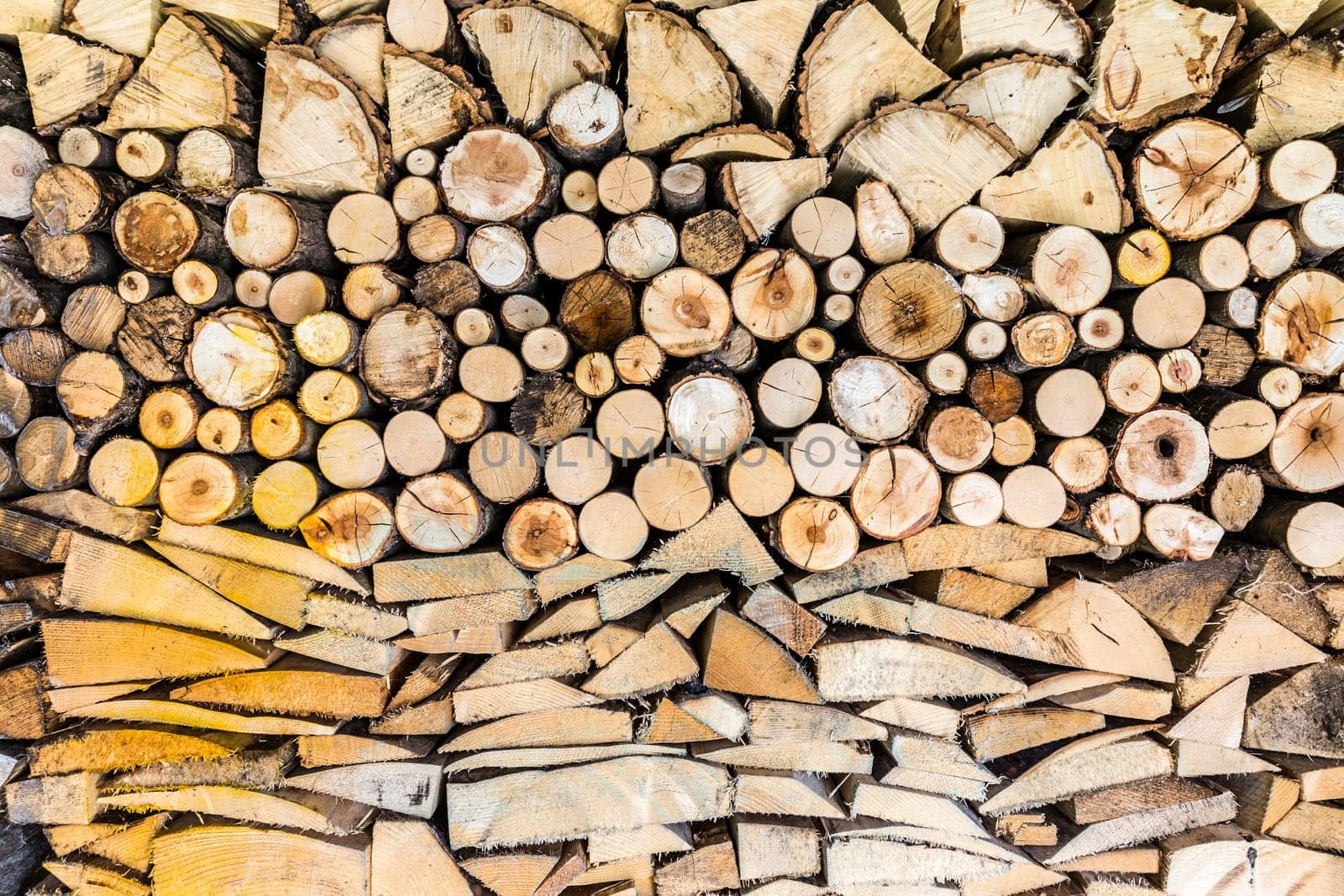 Pile of wood logs ready for winter in the garden