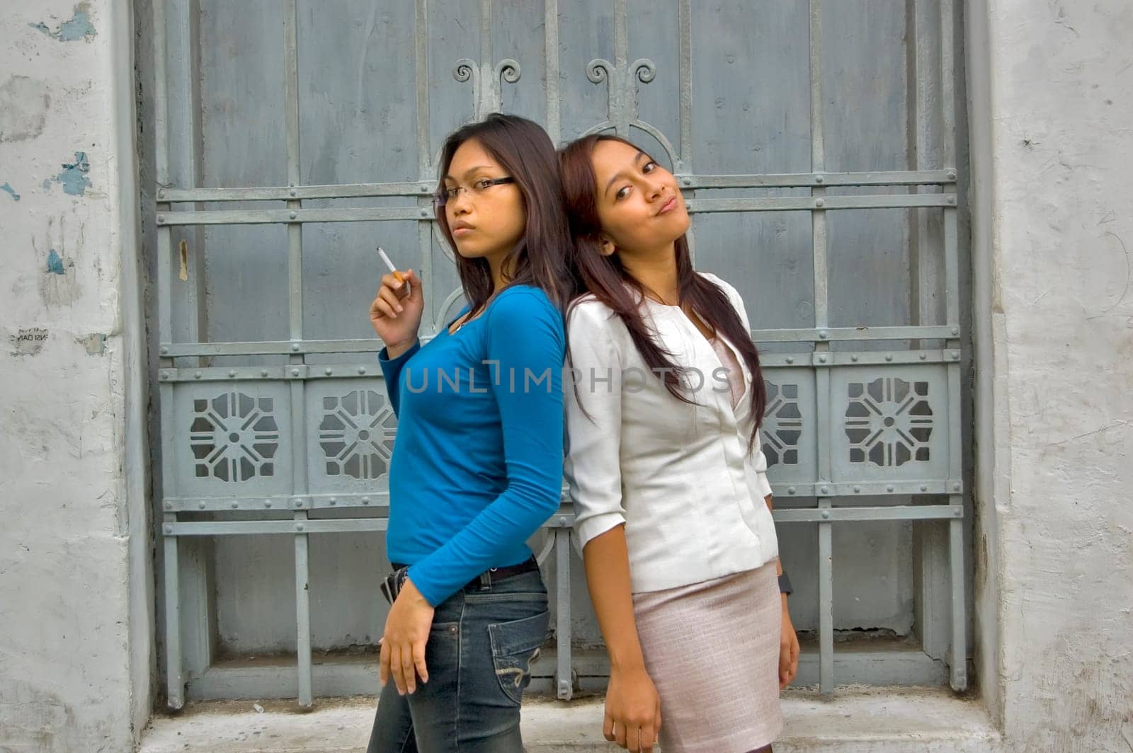 Two Young Asian Girl at Outdoor wearing white suit and blue shirt
