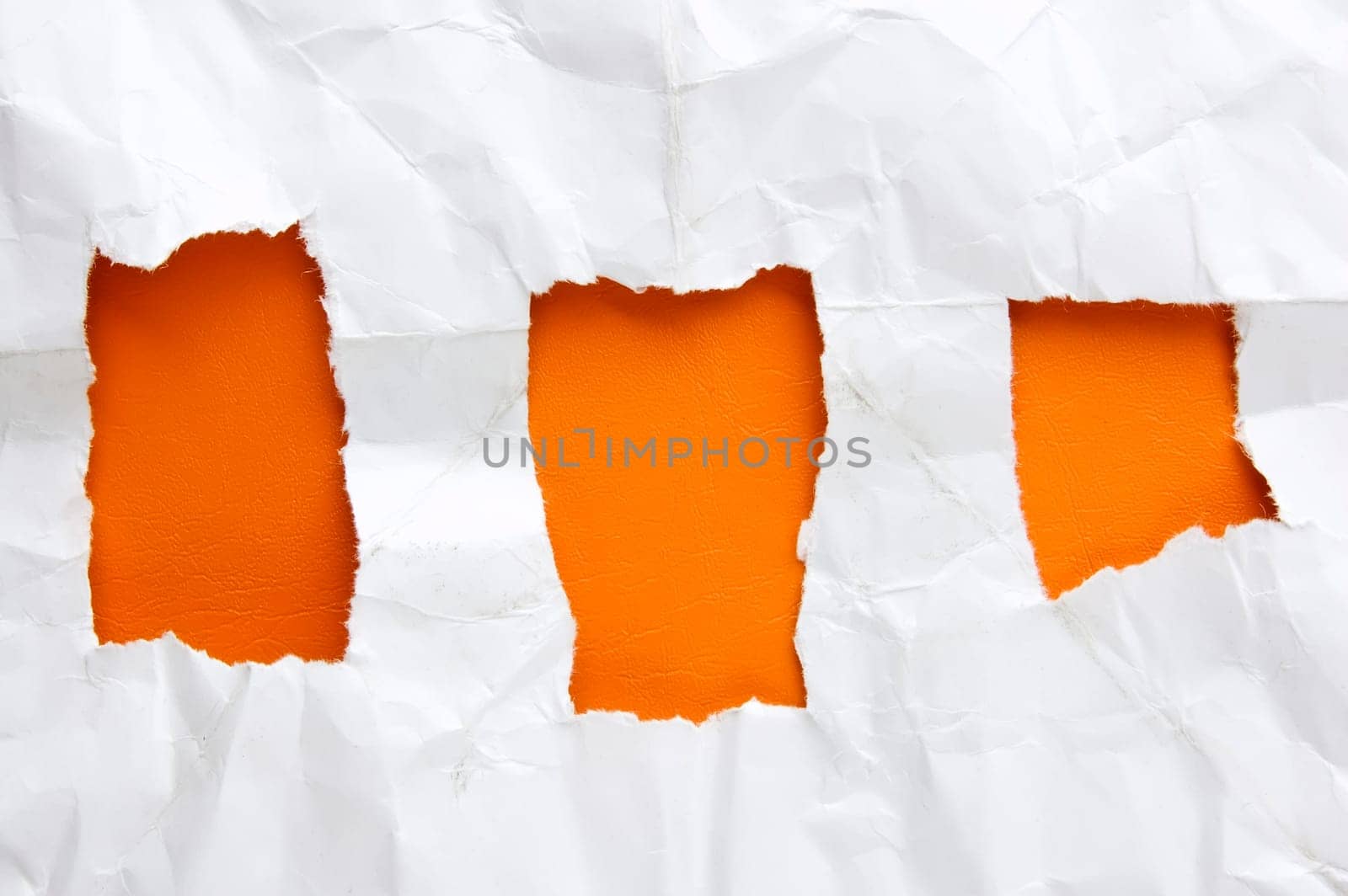 Sheet of torn paper againts orange background