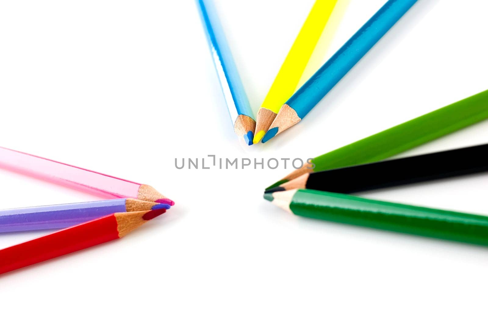 Many pencils of different colors on a over white background.