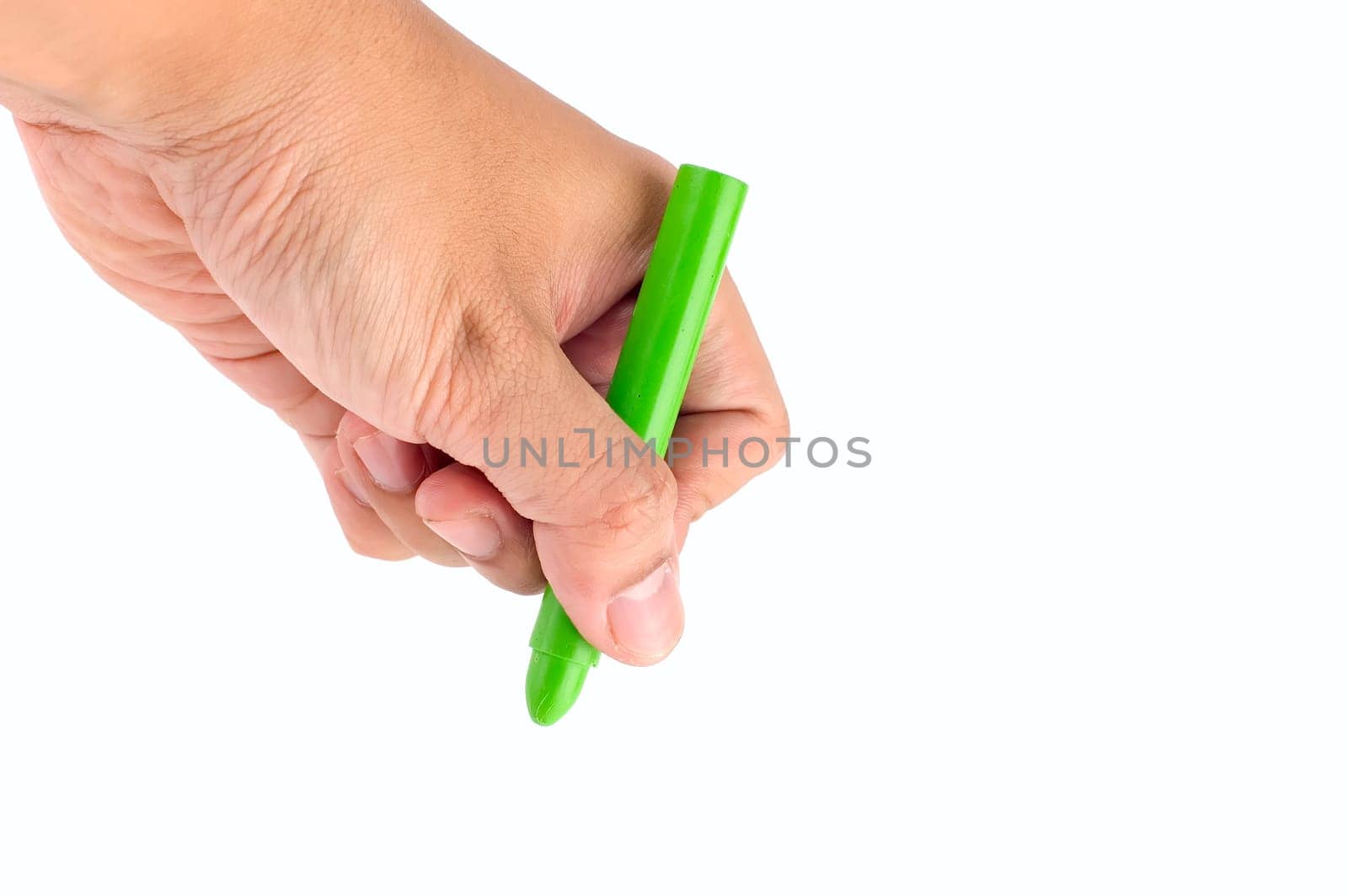 Hand holds green crayon. Ready to draw
