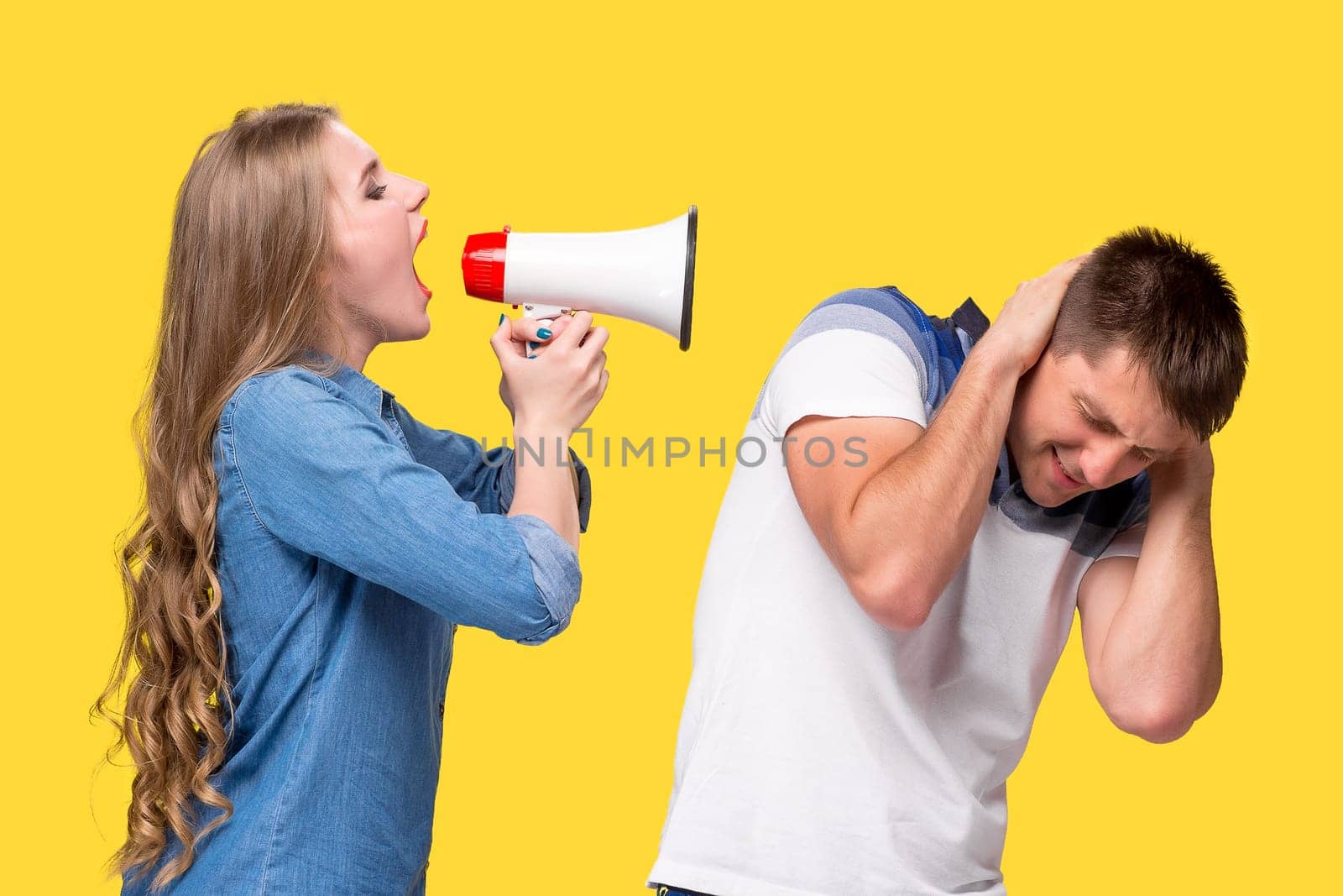 Woman shouting in megaphones with woman at each other