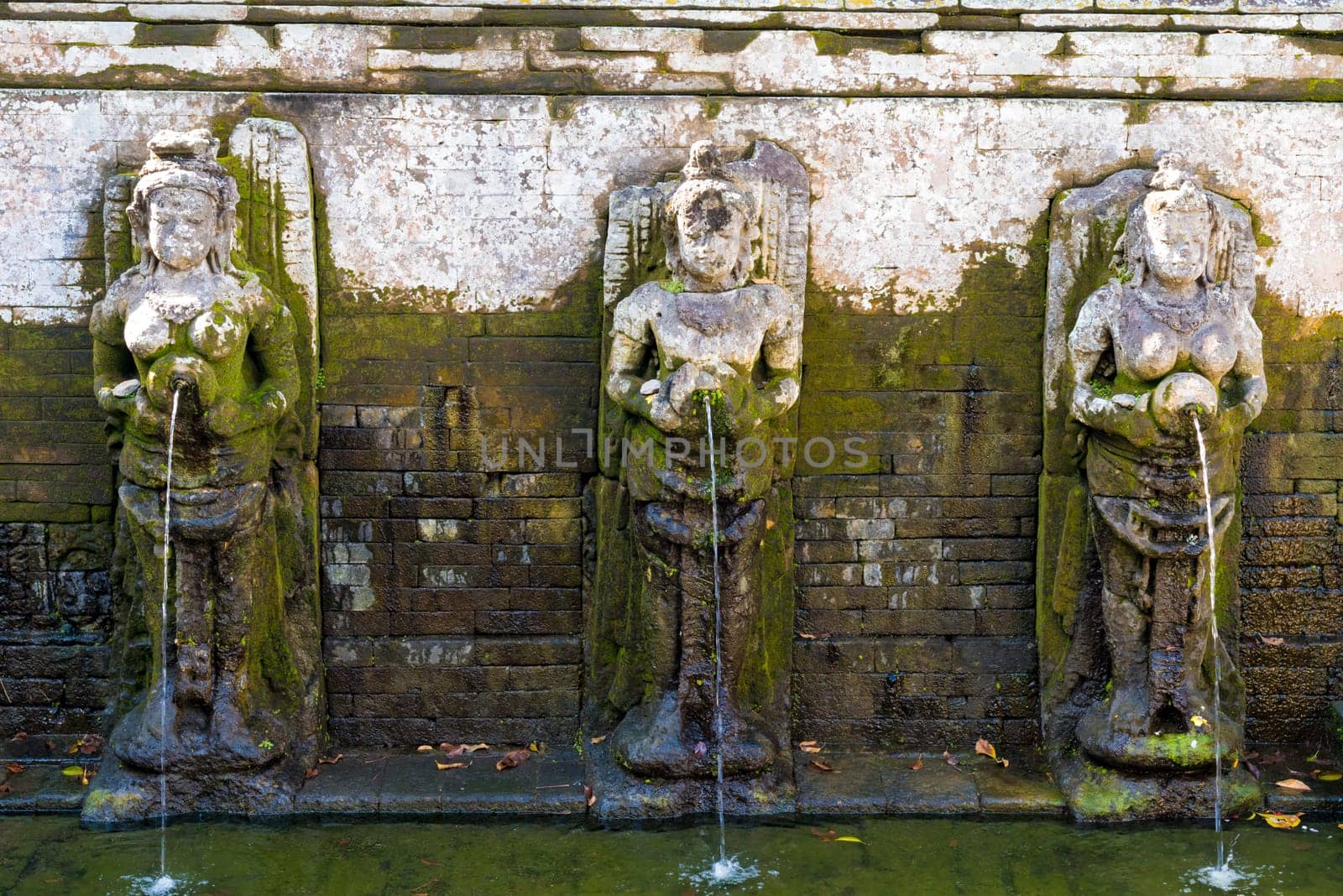 Bali, Indonesia - May 1, 2017 : Bathing Temple Figures at the Goa Gajah Elephant Cave Temple near Ubud, Bali, Indonesia
