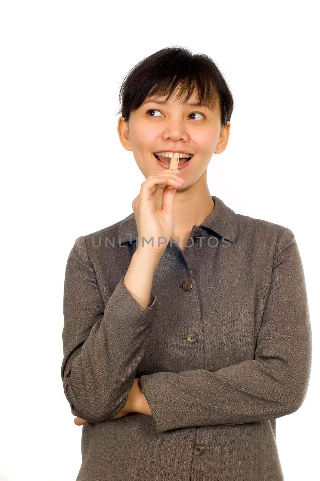 Young Beatiful Asian Woman eating cookie on white background
